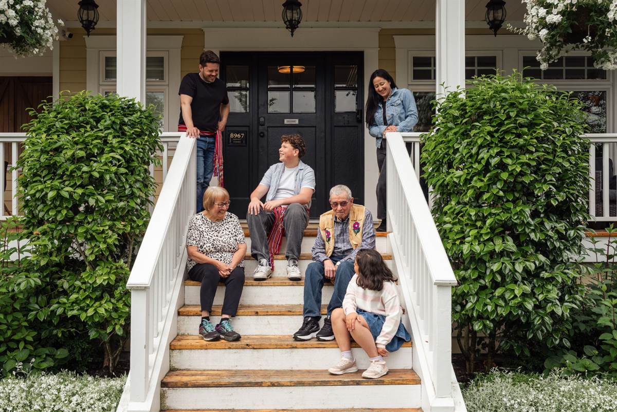 A family on the porch of their home